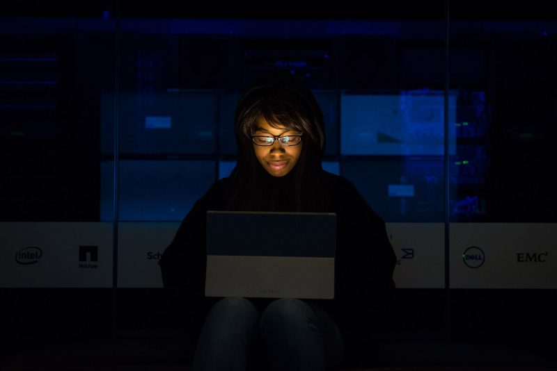 Mulher usa óculos com lente blue protect para trabalhar no escuro